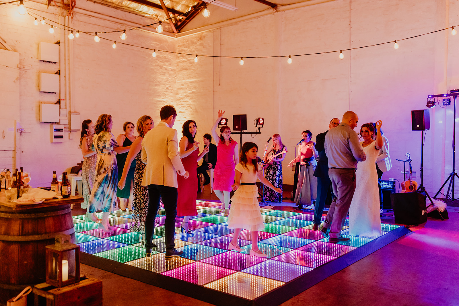 Wedding guests dancing on the rainbow 3D infinity dance floor in a Perth warehouse venue